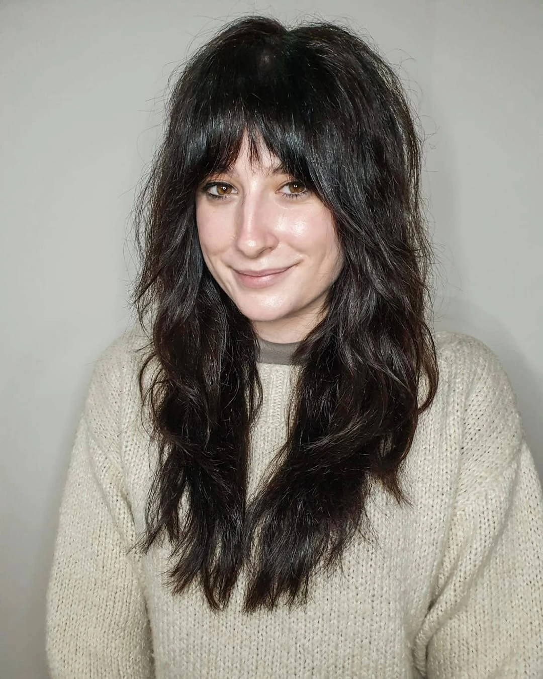 Long black shag with wispy bangs and feathered layers