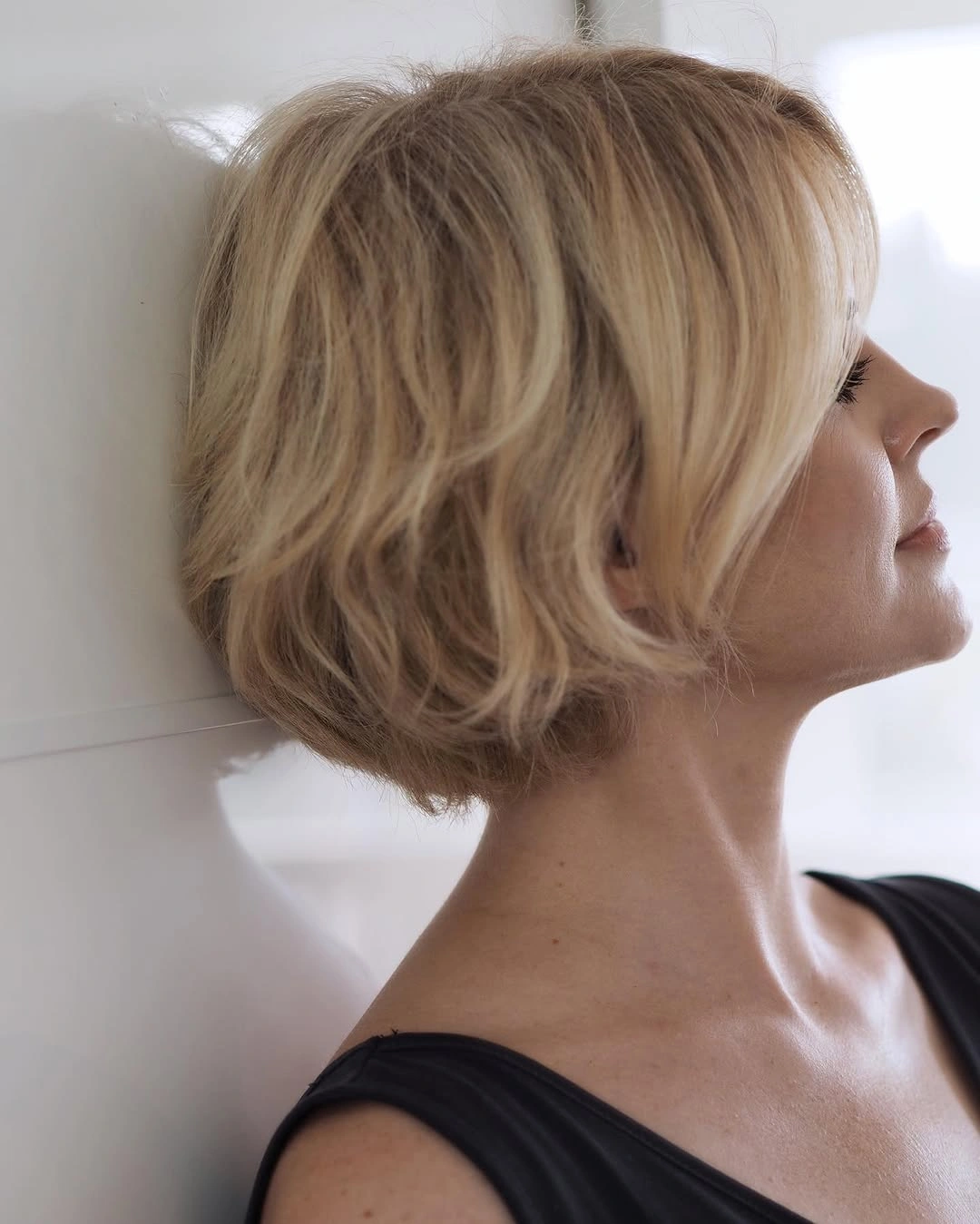 Blonde stacked bob with tapered nape and longer front pieces