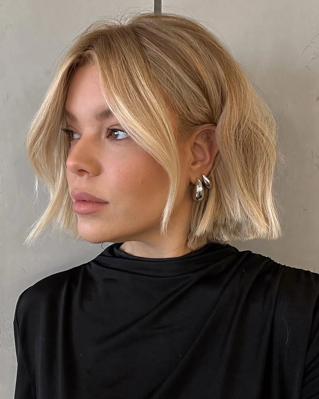 Blonde short bob partially gathered with loose front pieces