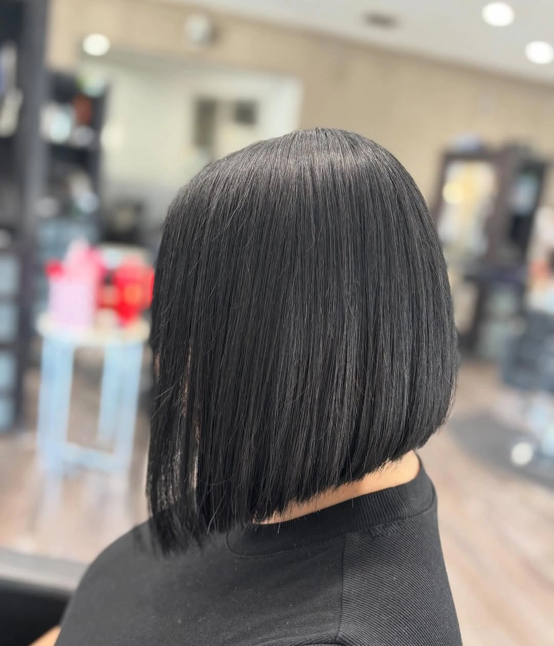 Sleek black bob with strongly slanted lower perimeter