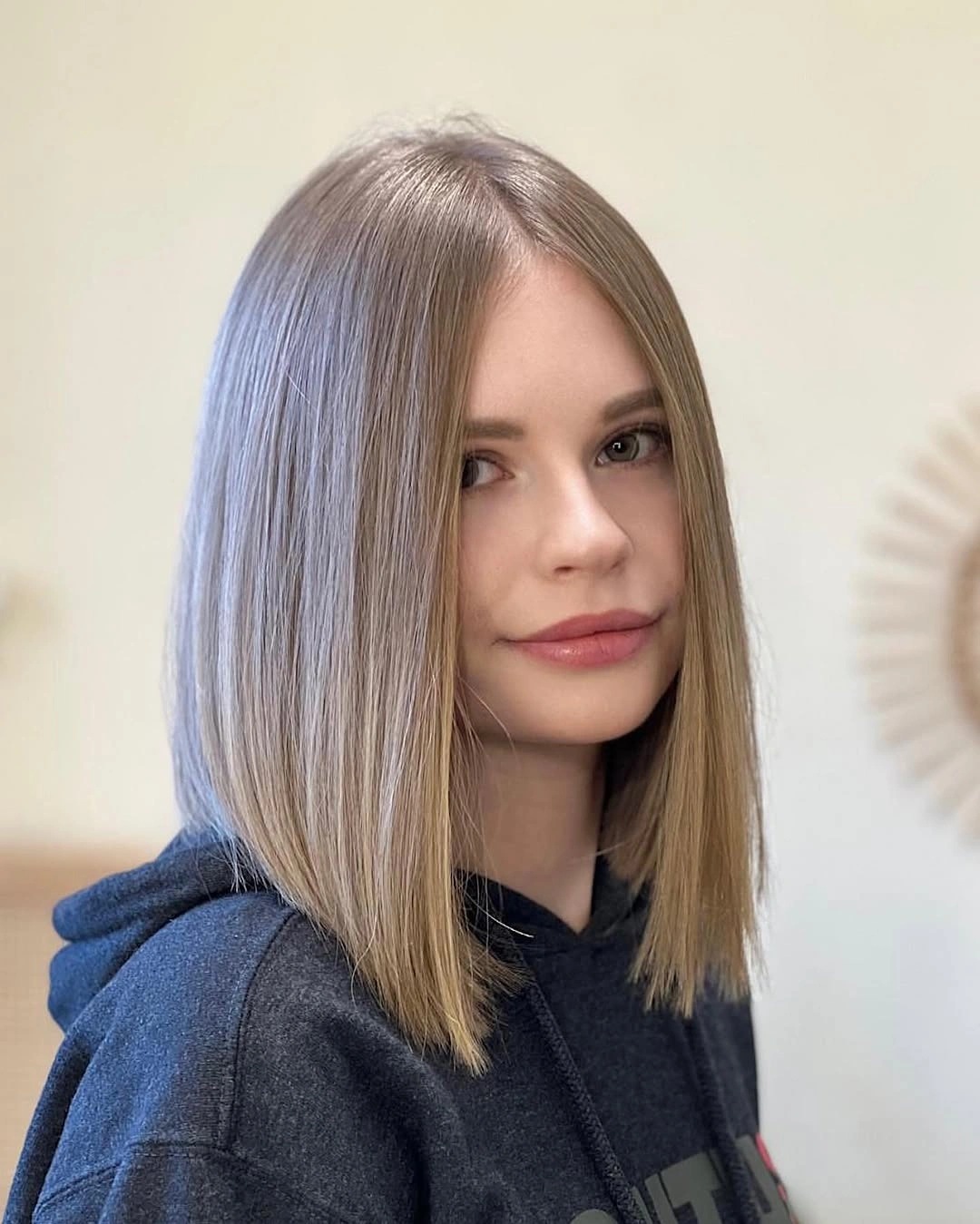 Straight ash-beige lob with center part and clean ends