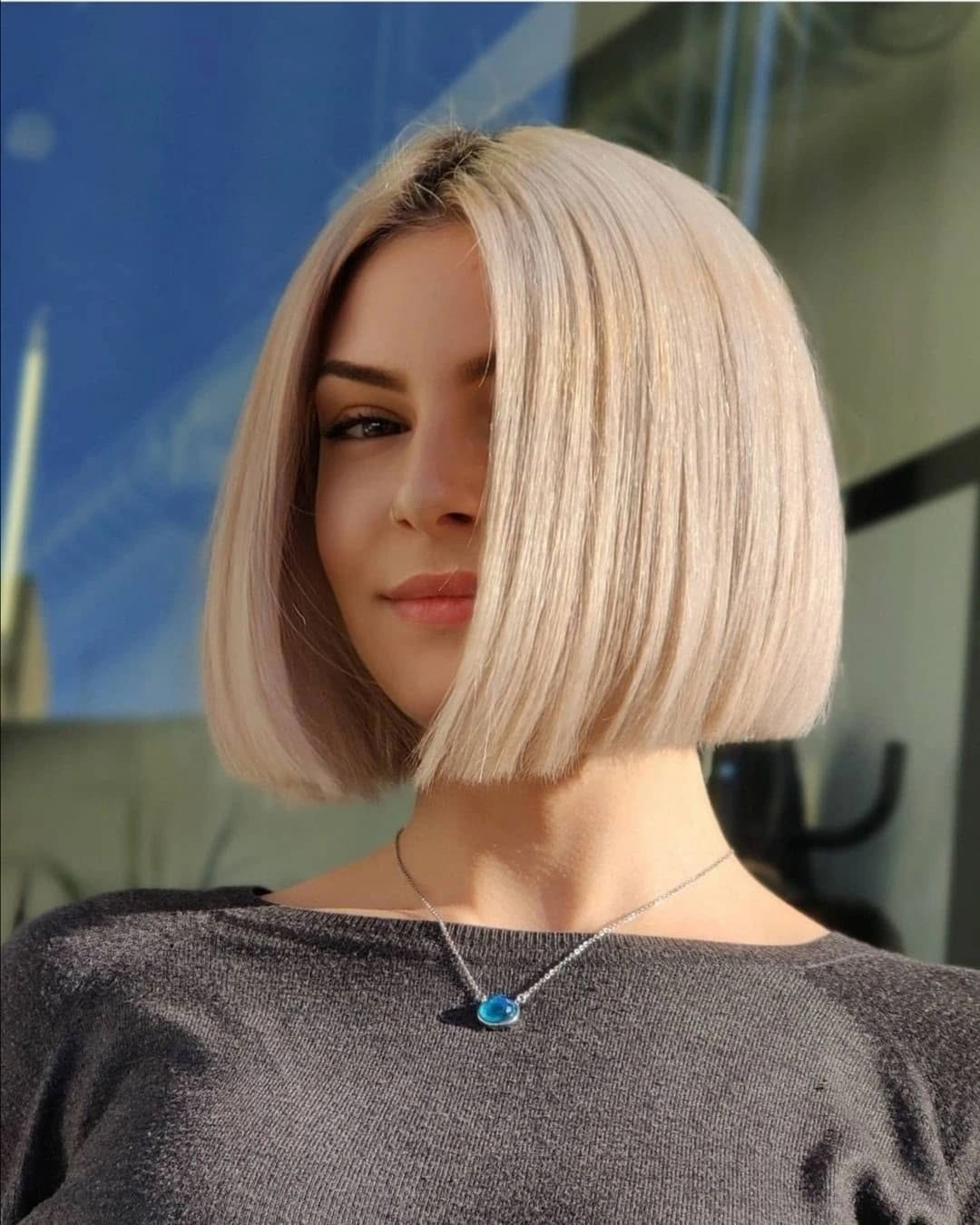 Very light blonde chin-length bob with straight blunt perimeter