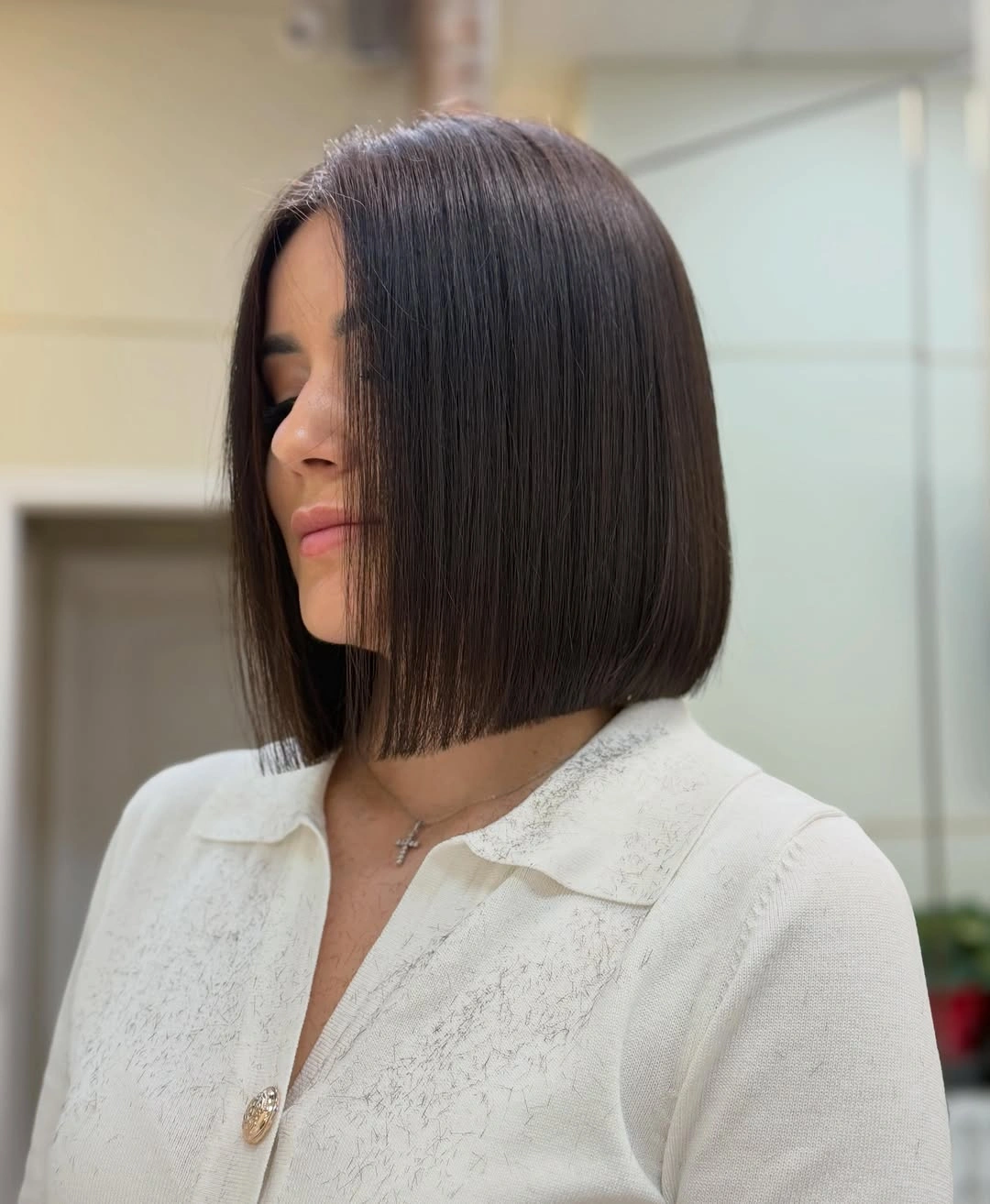Sleek dark brown bob with blunt chin-length ends