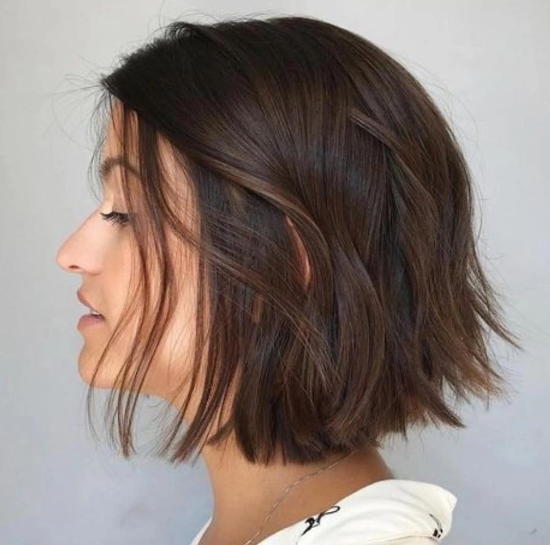 Tousled brunette bob with shorter nape and longer front pieces