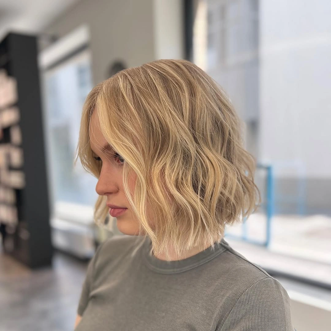 Light blonde chin-length bob with loose soft waves