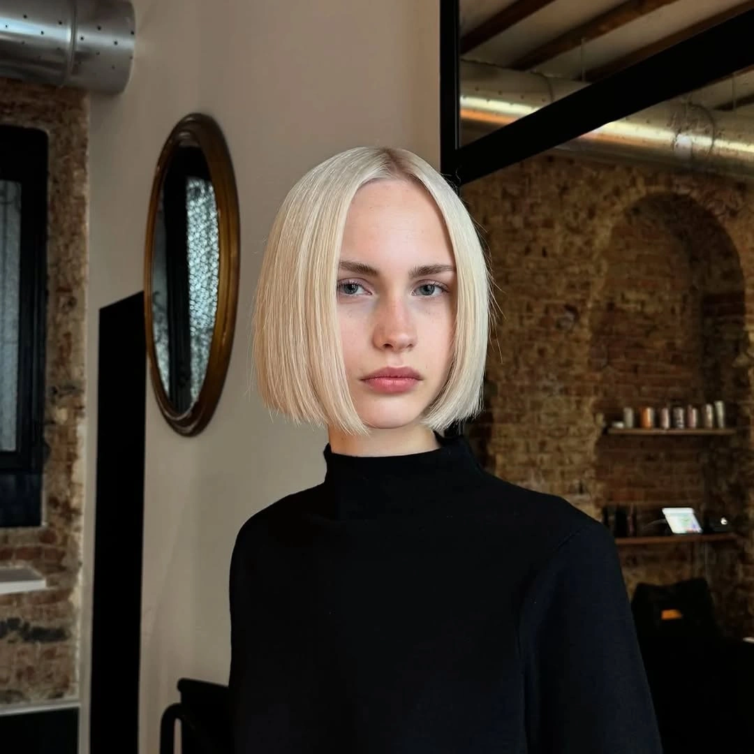 Very light blonde jaw-length bob with crisp blunt ends