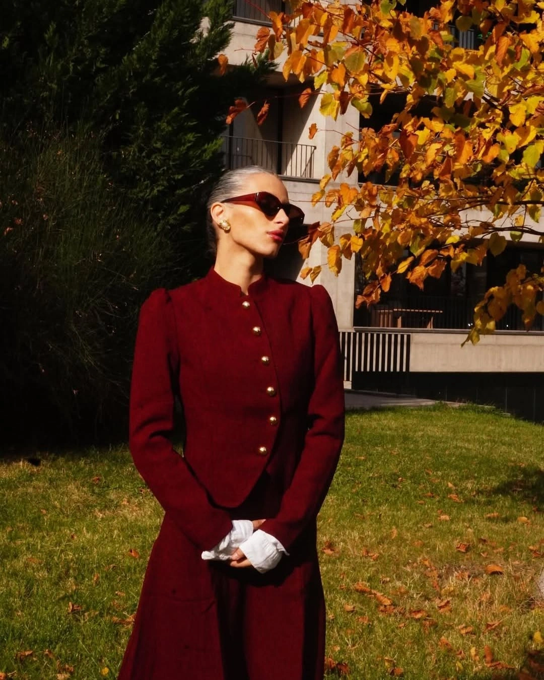 Deep burgundy buttoned jacket with matching lower layer and white gloves