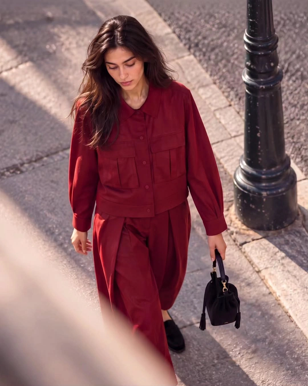 Red pocket jacket with matching wide trousers and black handbag