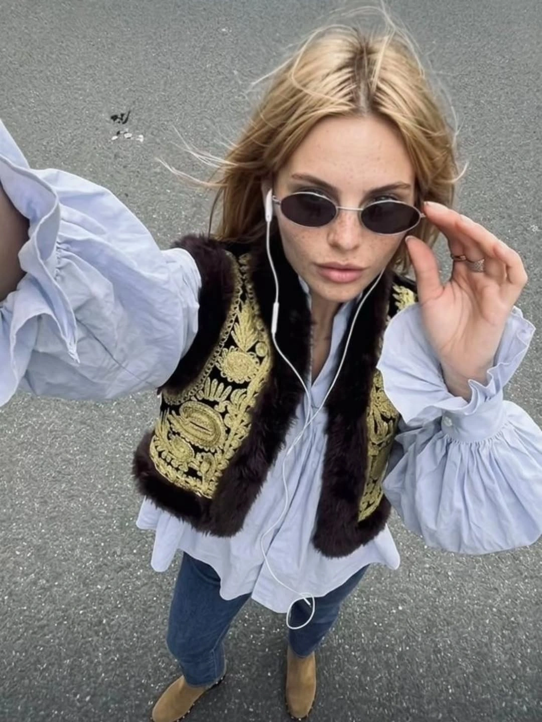 Ornate gold vest over pale blue blouse with jeans