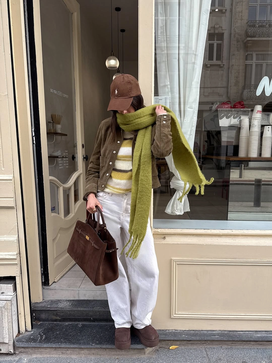 Olive scarf with brown jacket, striped knit and white jeans