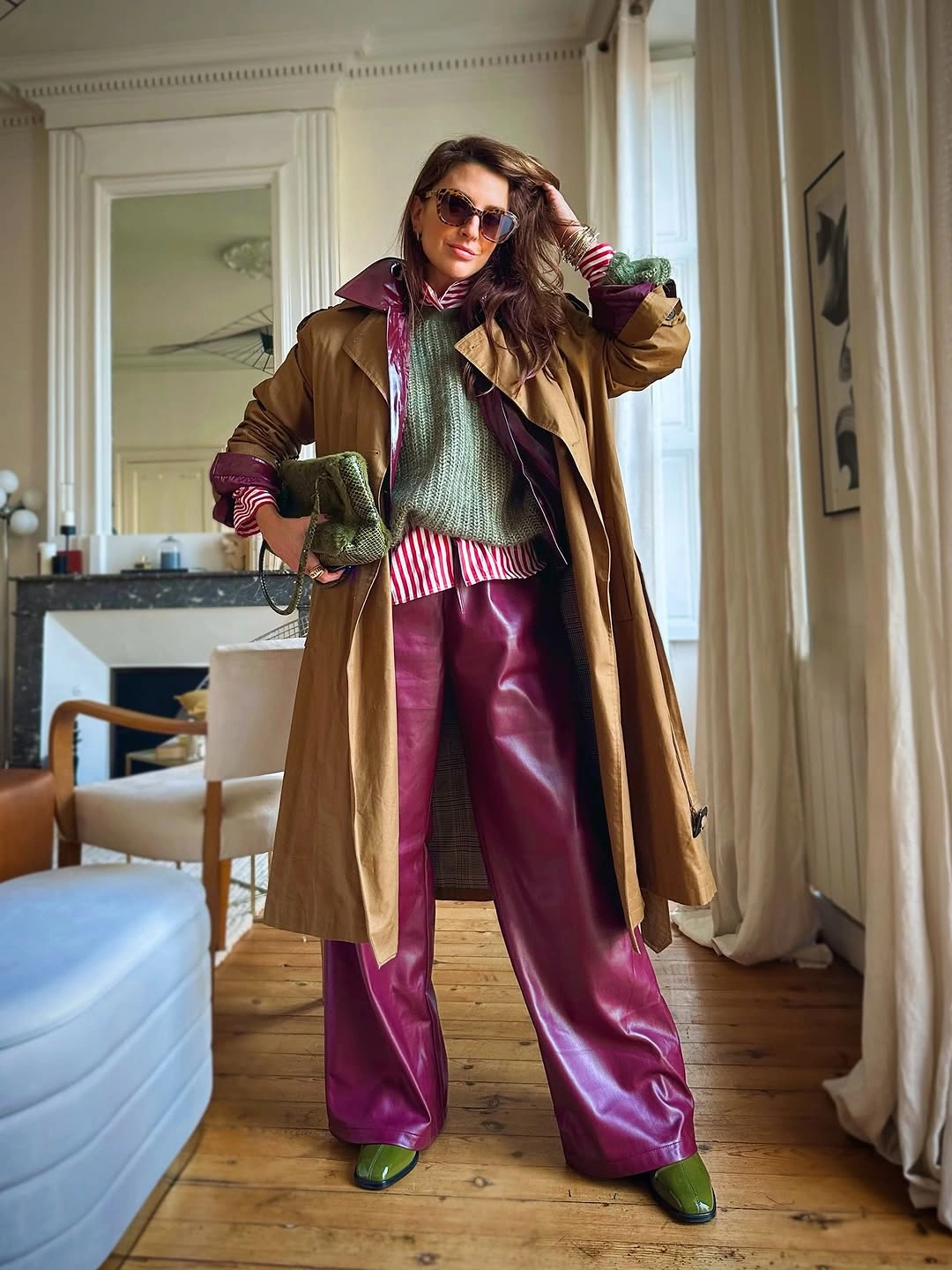 Tan trench coat with magenta trousers and green shoes