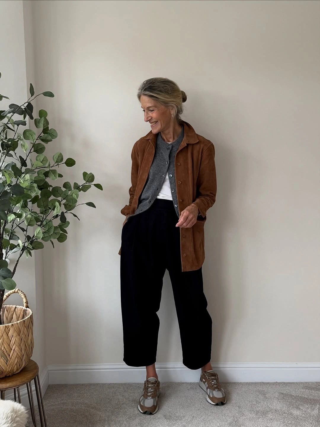 Brown long shirt jacket with cropped black trousers and sneakers
