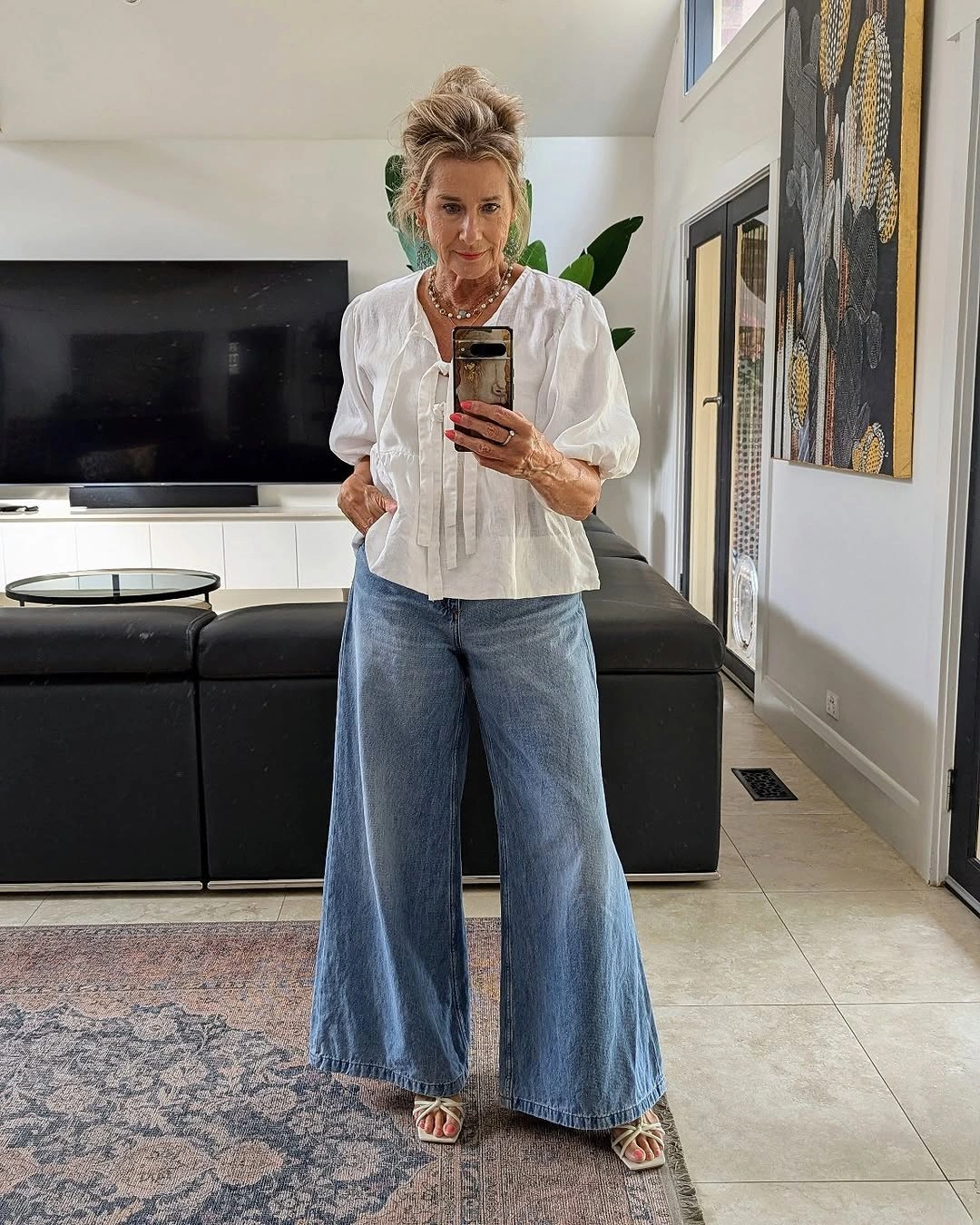 White tie blouse with wide light blue jeans