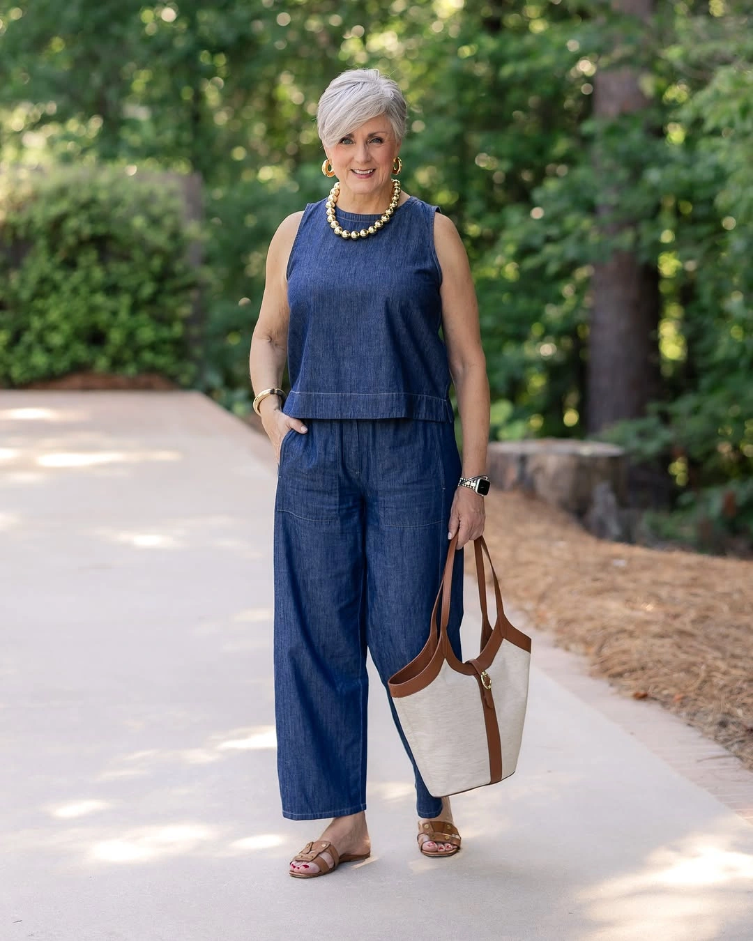 Sleeveless denim outfit with chunky necklace and tan tote