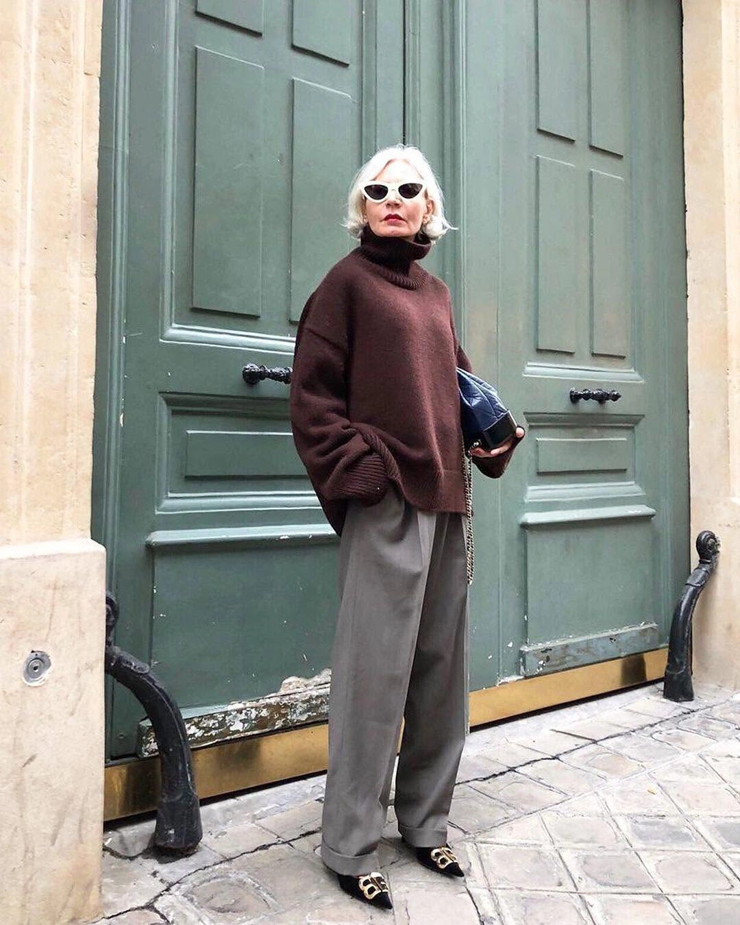 Dark brown oversized turtleneck with gray wide trousers