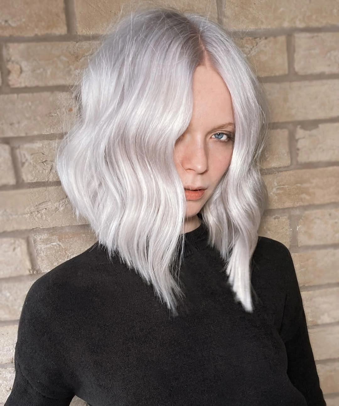 Shoulder-length silver-white blonde bob with soft waves