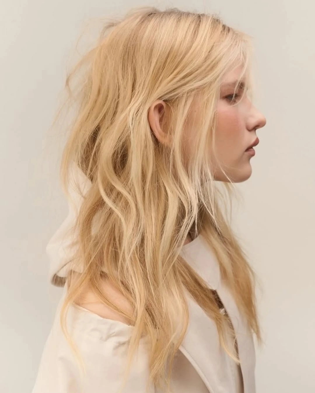 Long pale golden blonde with loose layered waves