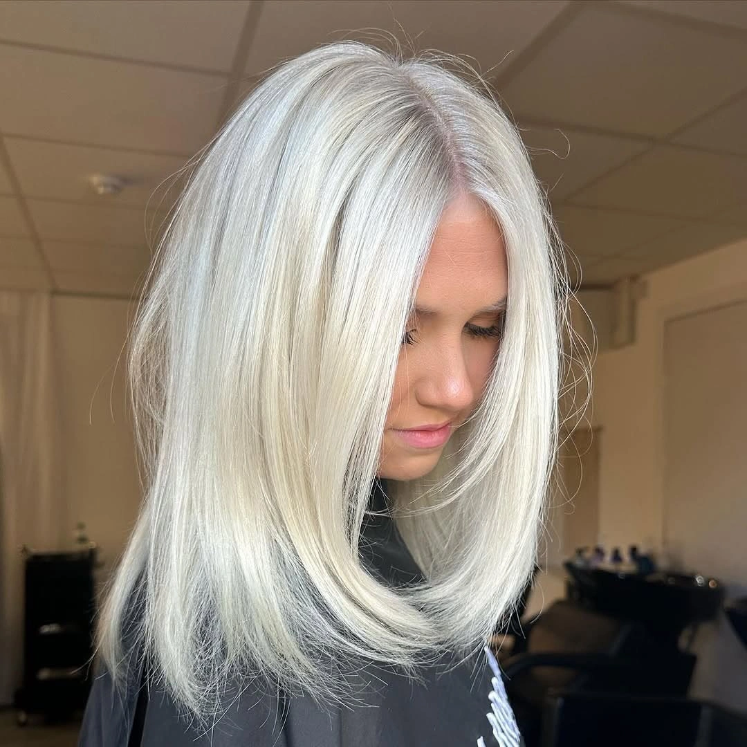 Smooth icy blonde long bob with curved ends