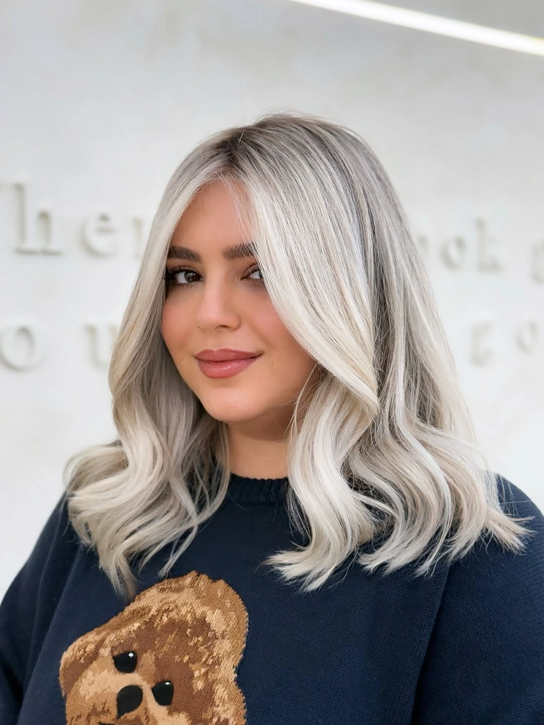 Cool shoulder-length blonde with dark roots and pale lengths