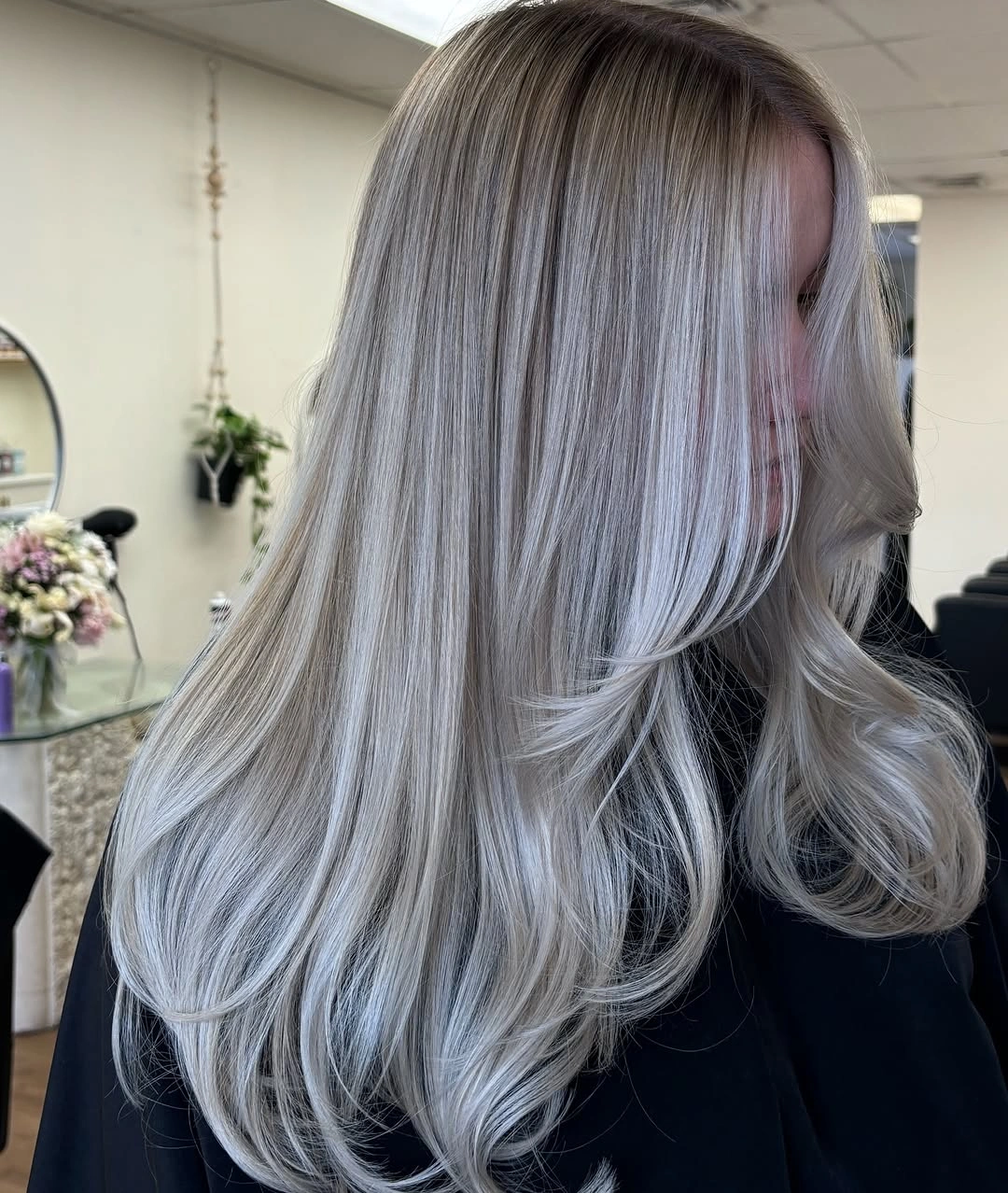 Long silver-gray blonde with dark roots and layered ends