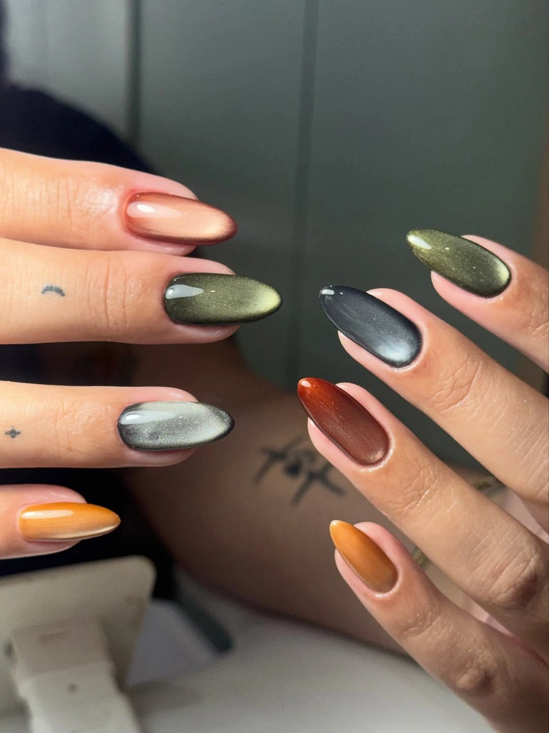 Reflective green gray orange and brown almond nails