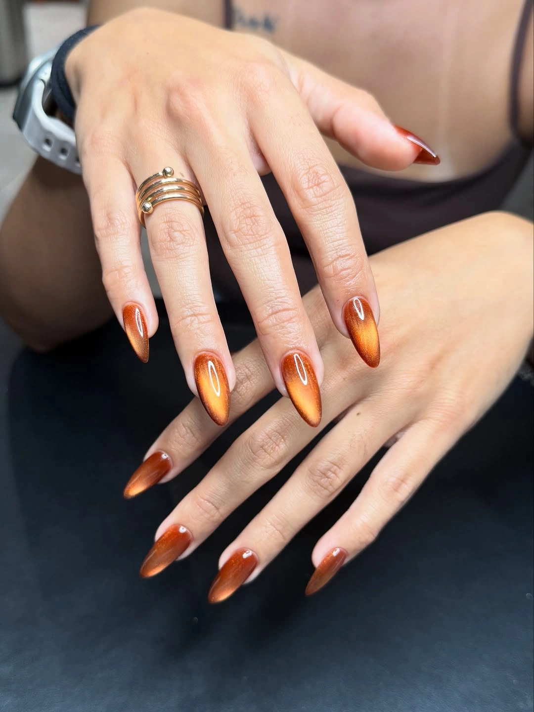 Long pointed nails with glossy amber brown gradients
