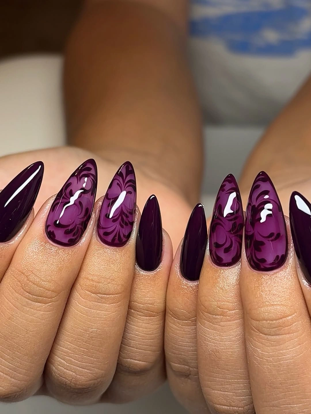 Long plum almond nails with translucent patterned accents