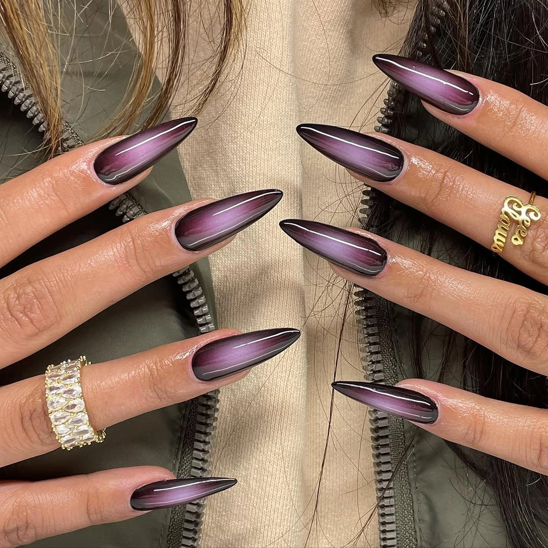 Purple reflective almond nails with dark borders and glossy streaks