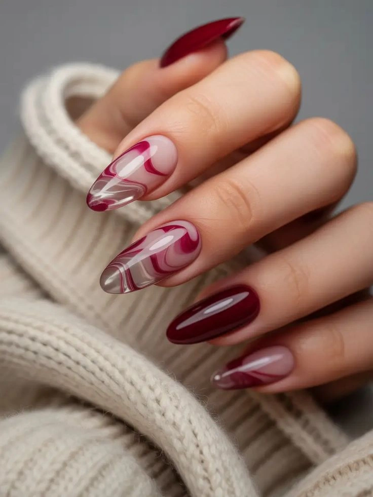 Almond nails with wine red curves and sheer spaces