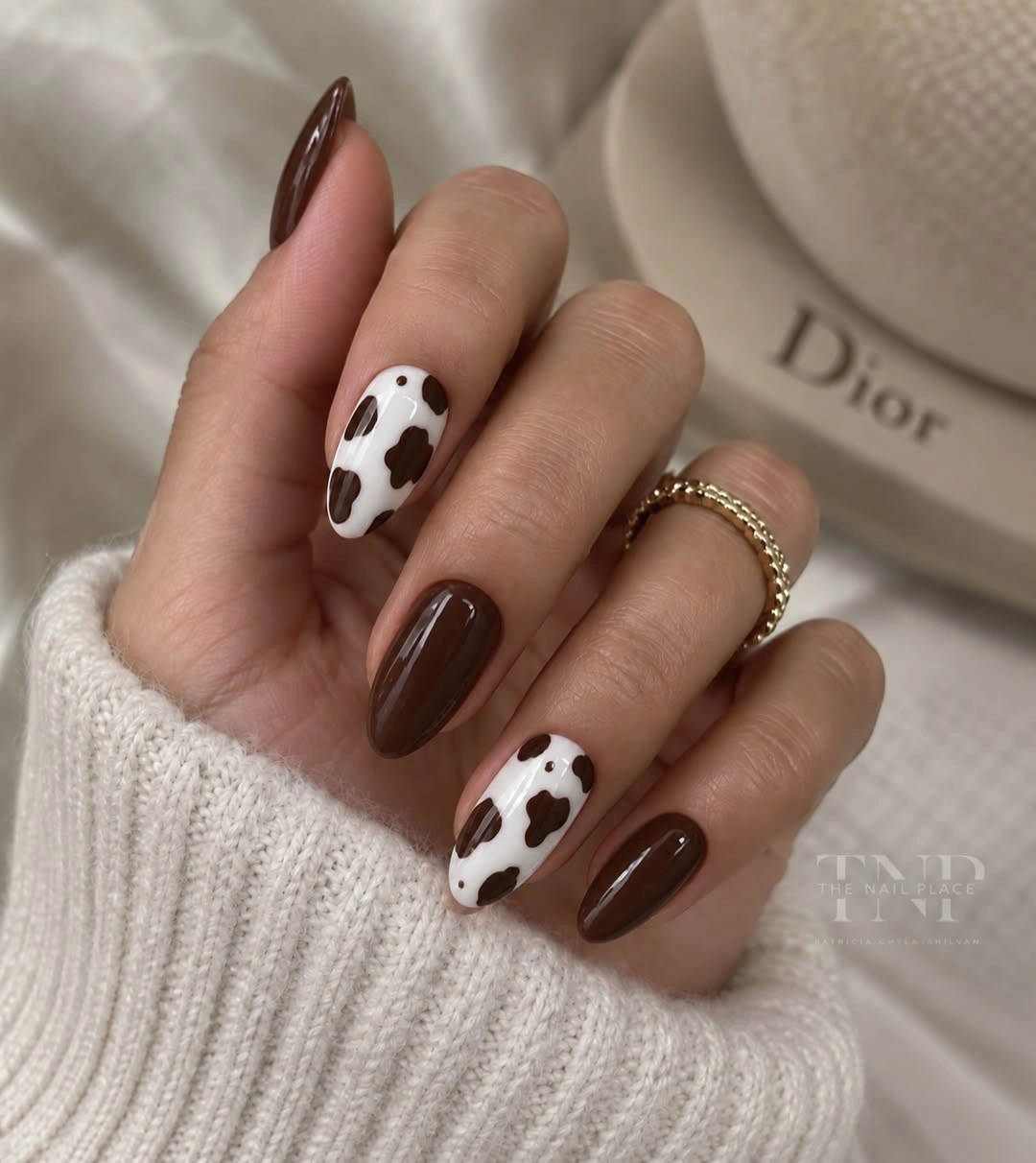 Chocolate brown almond nails with white spotted accent nails