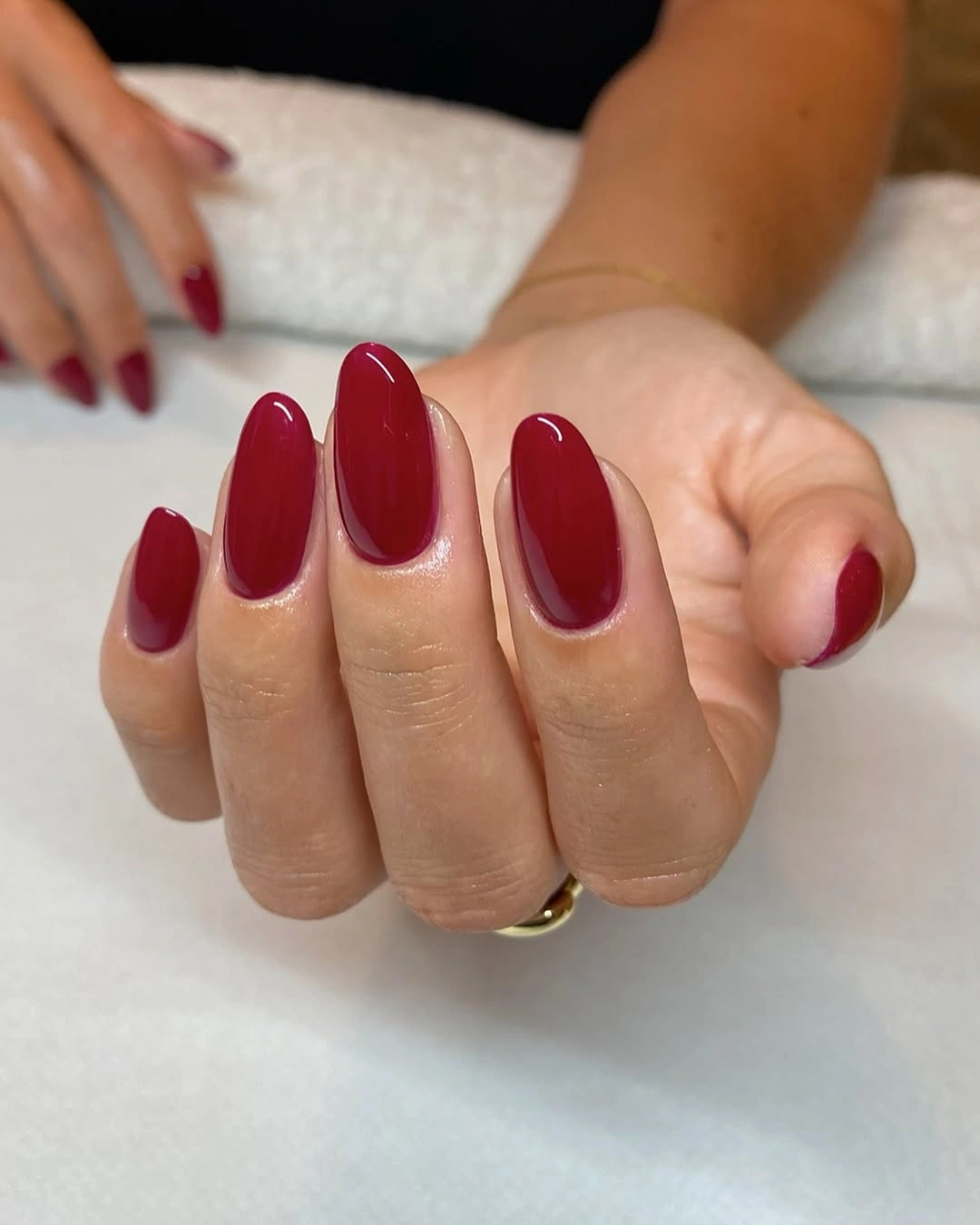 Glossy red almond nails with rounded tapered tips
