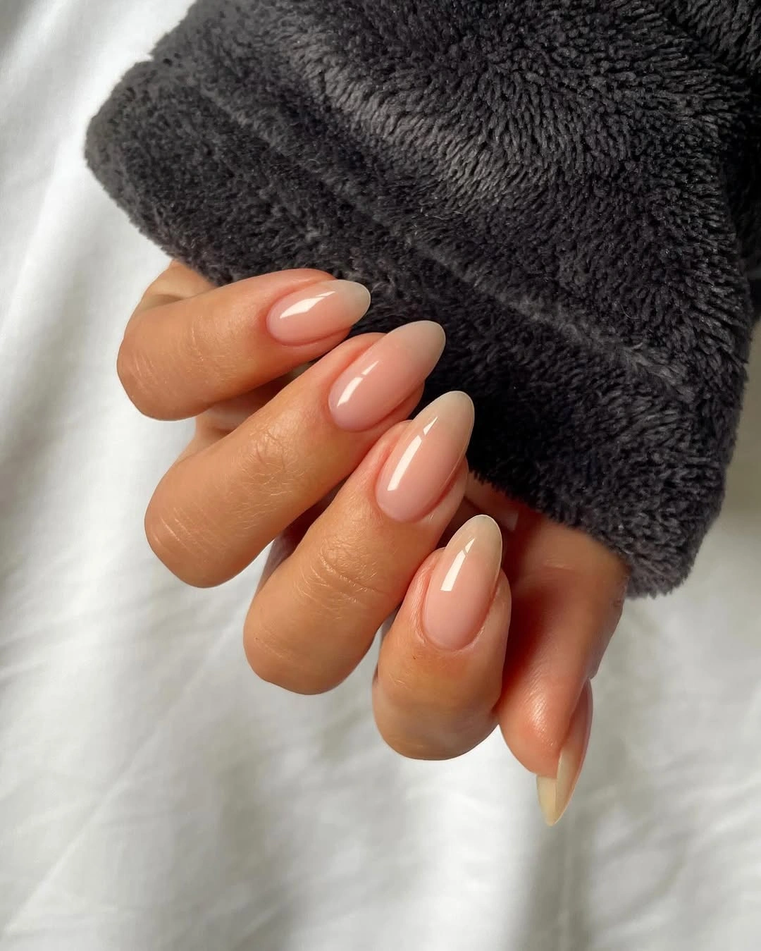 Nude almond nails with soft creamy French tips
