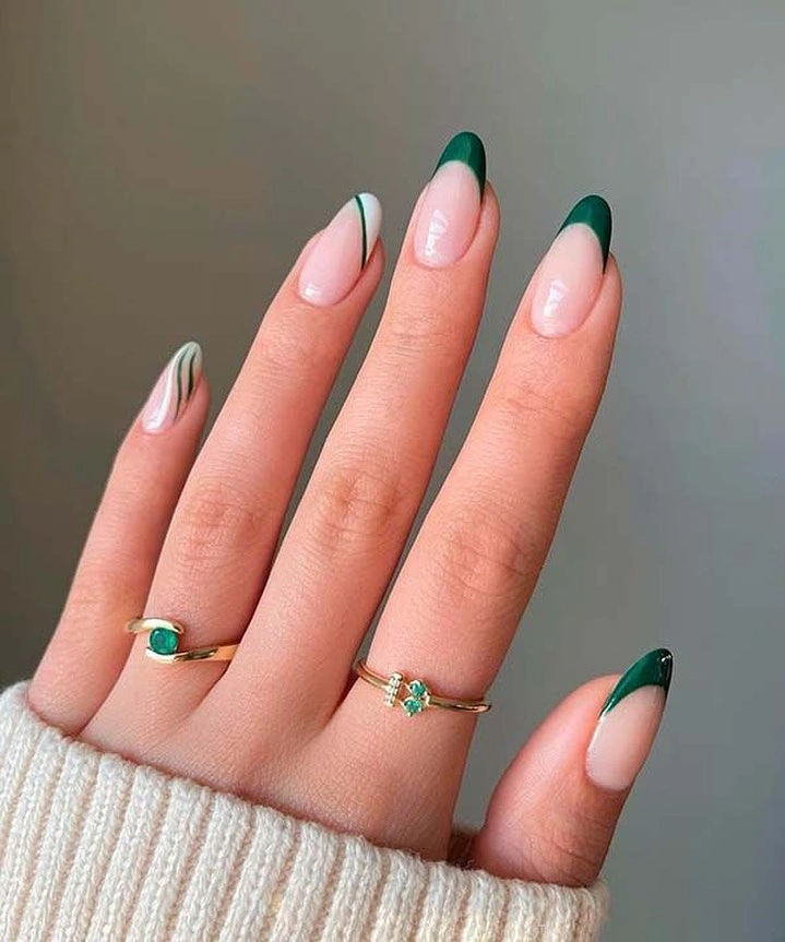 Pale pink almond nails with deep green French tips