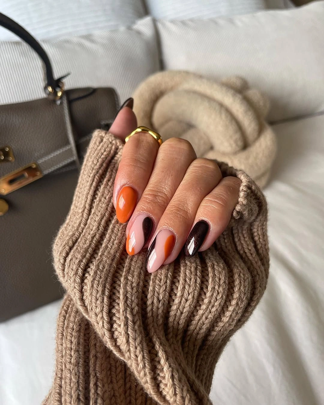 Almond nails in orange pink and dark brown