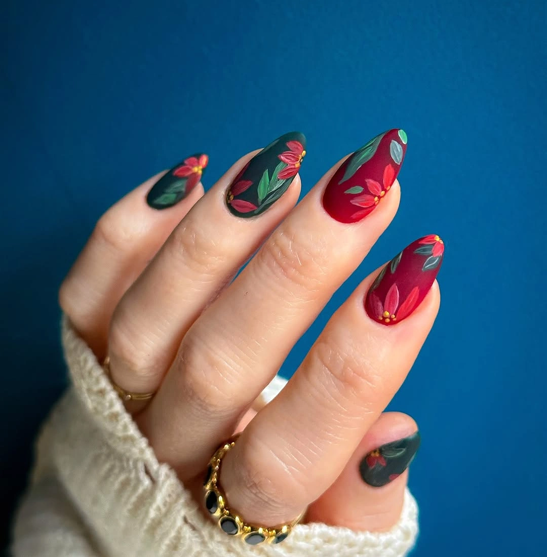 Almond nails with deep green red flowers and leaves