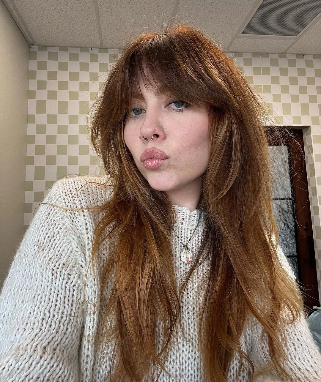 Long warm brown hair with full bangs and soft layers