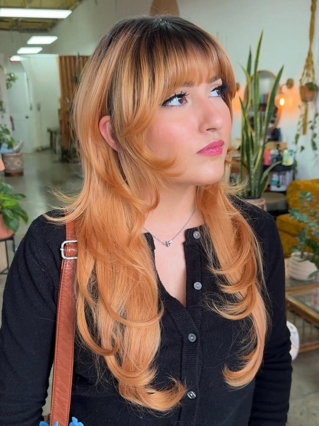 Long peach-orange layers with bangs and rounded face pieces