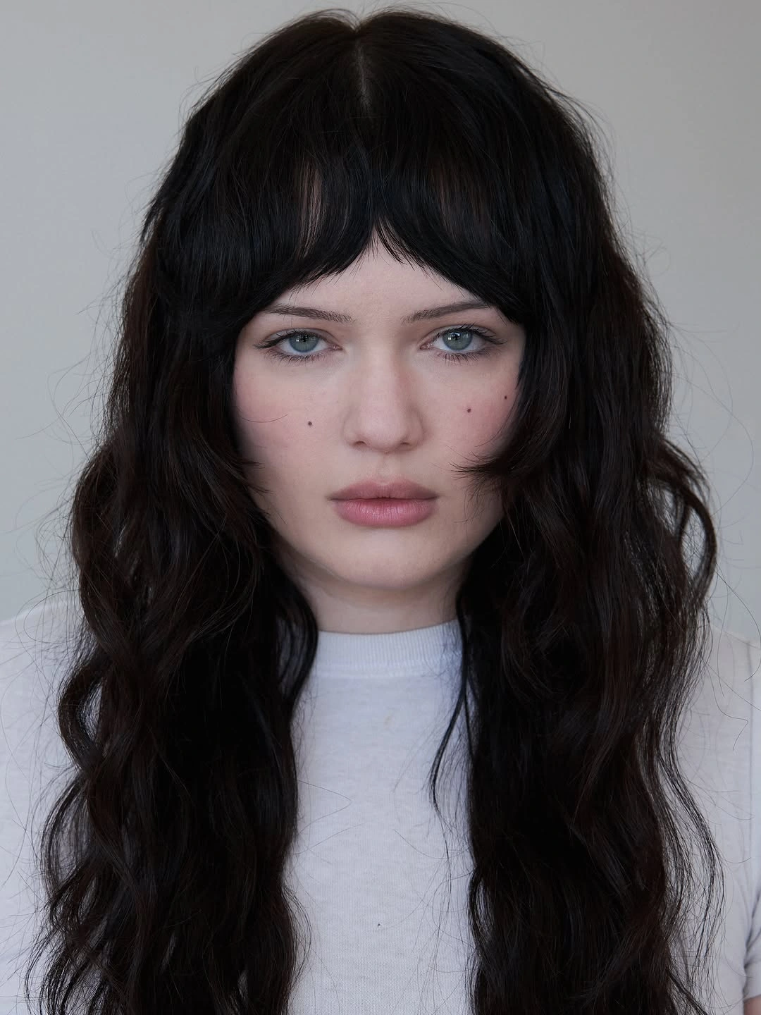 Long dark wavy hair with soft center fringe