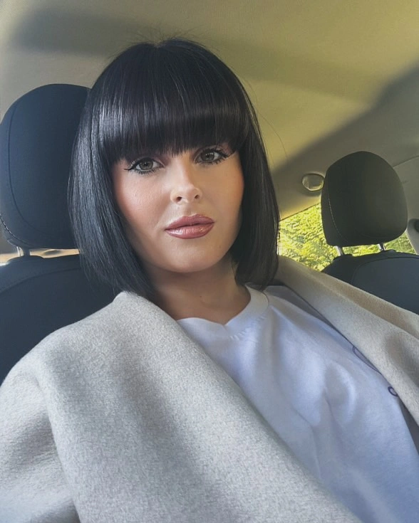 Glossy black blunt bob with heavy straight bangs