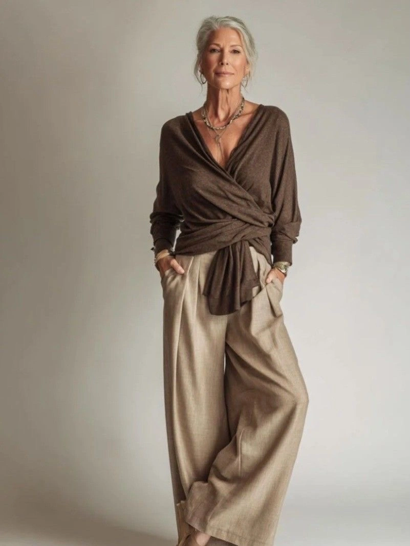 Brown wrap top with fluid beige wide bottoms and necklaces