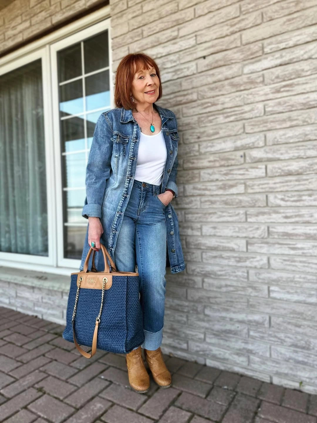 Denim jacket with jeans, white top and tan boots