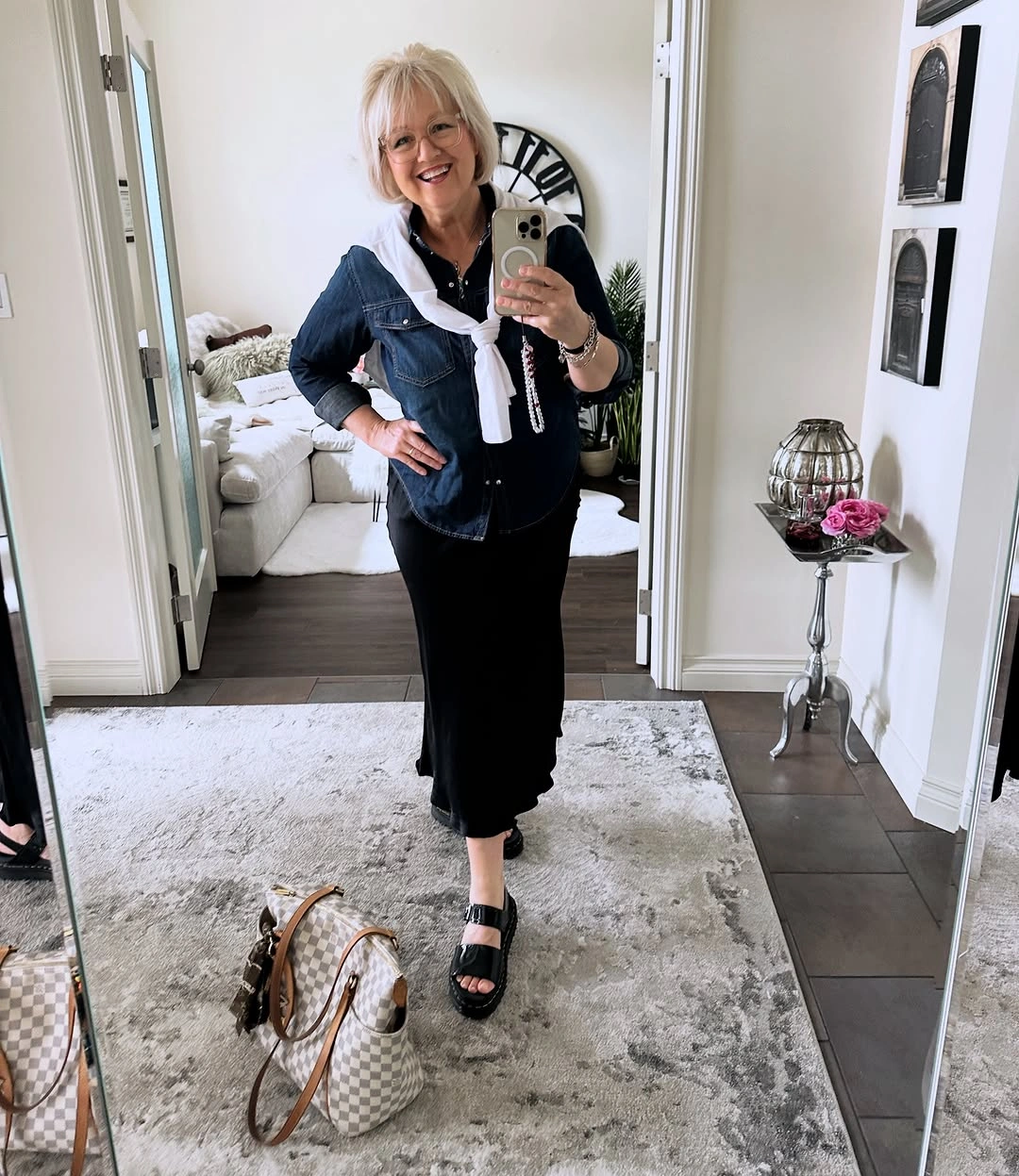 Denim jacket over black column with white shoulder sweater
