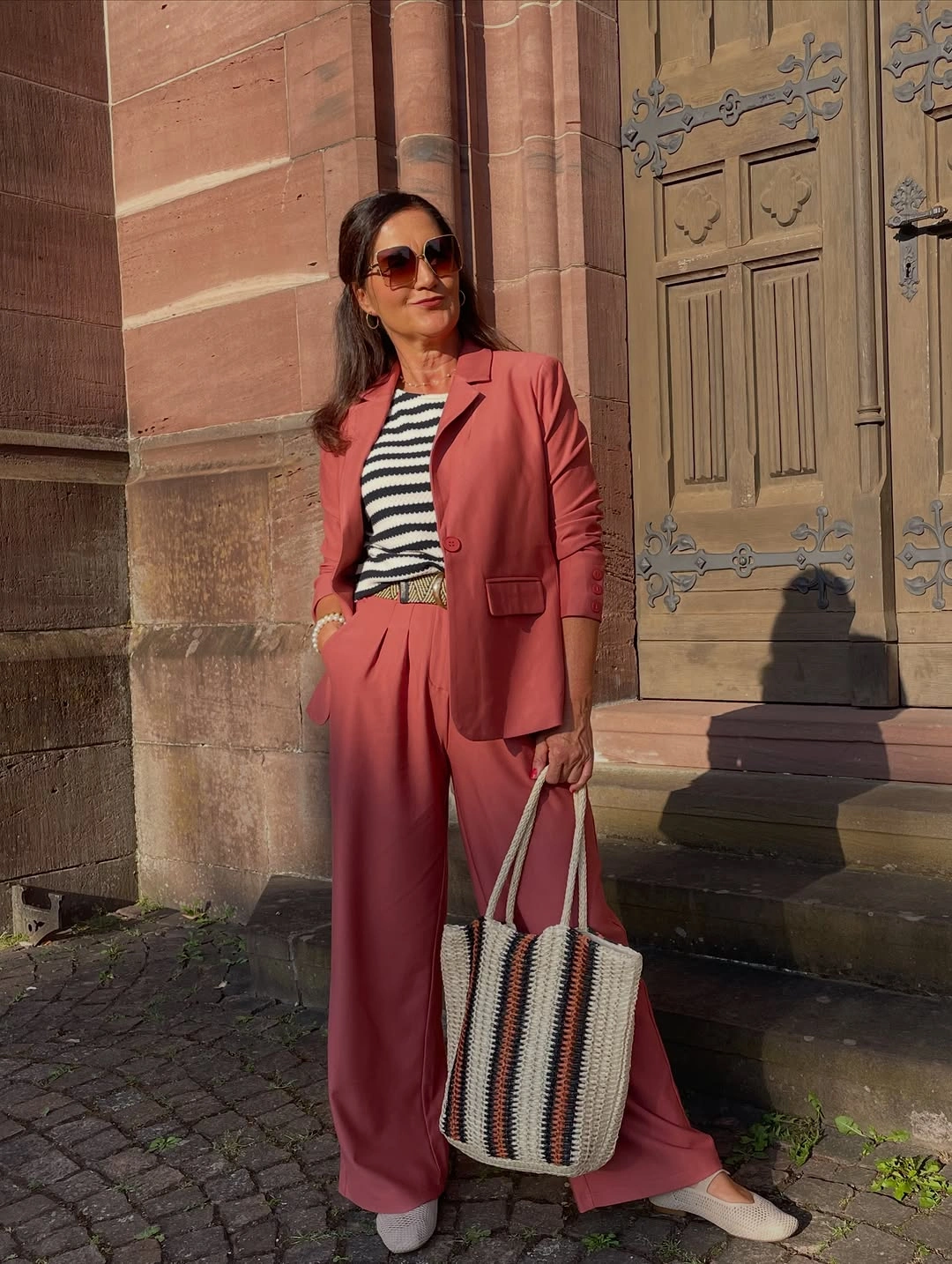 Rose blazer and wide trousers with striped top
