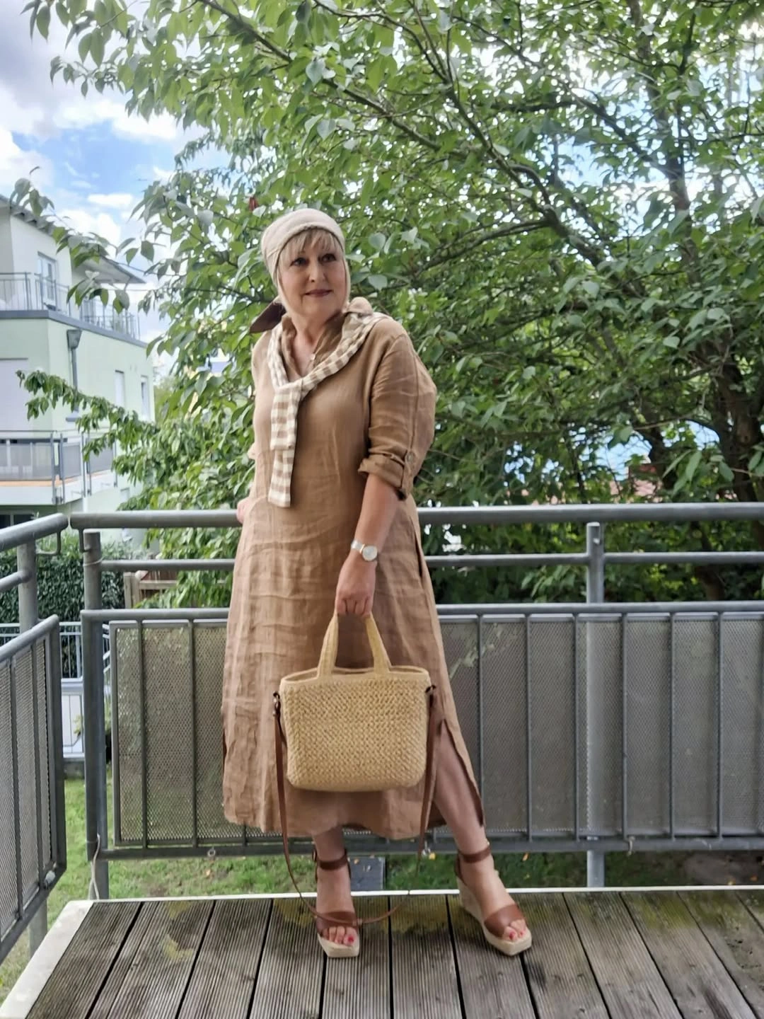 Tan long buttoned piece with cream cap and woven tote