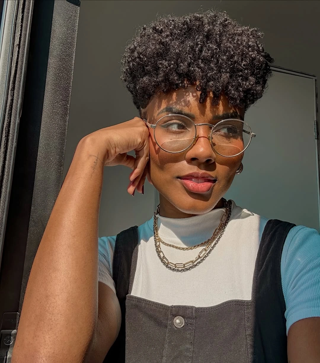 Short curly crop with close sides and round glasses