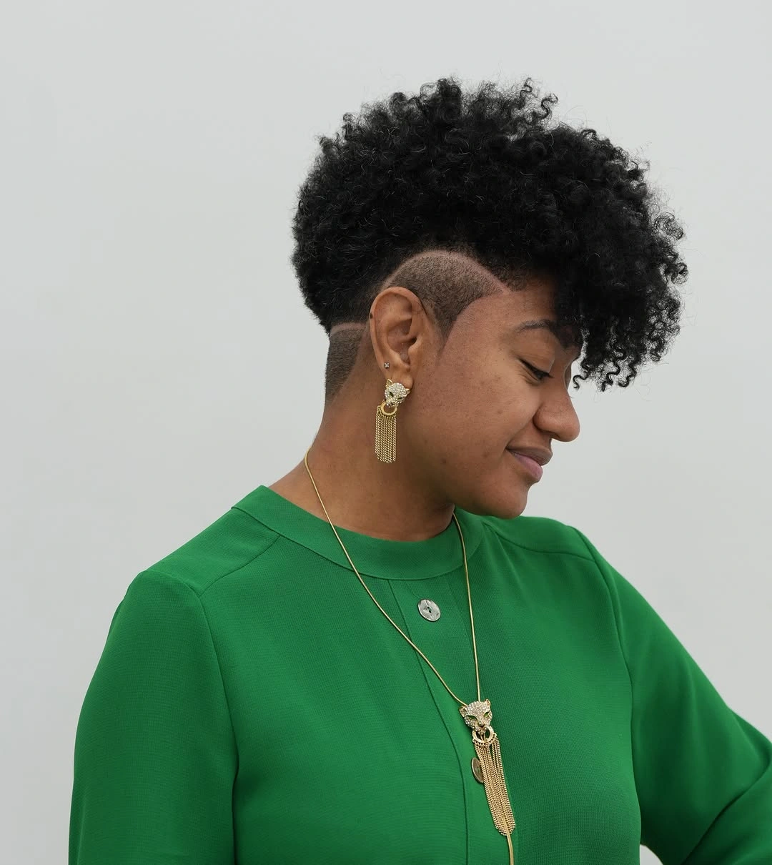 Curly undercut with etched side line and green top
