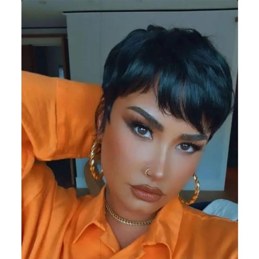 Cropped cut with side-swept fringe and gold hoops