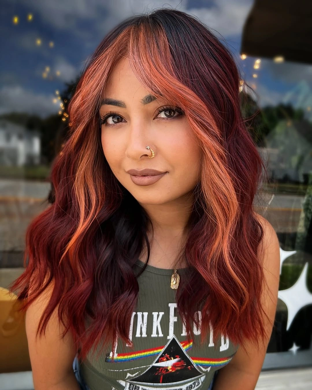 Shoulder-length burgundy waves with copper face-framing pieces