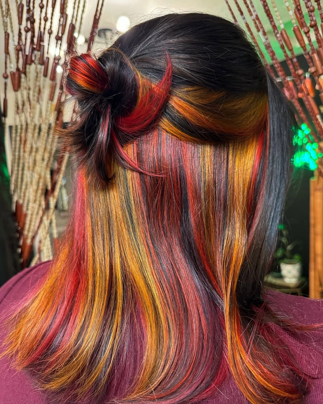 Half-up dark hair with red yellow and orange panels
