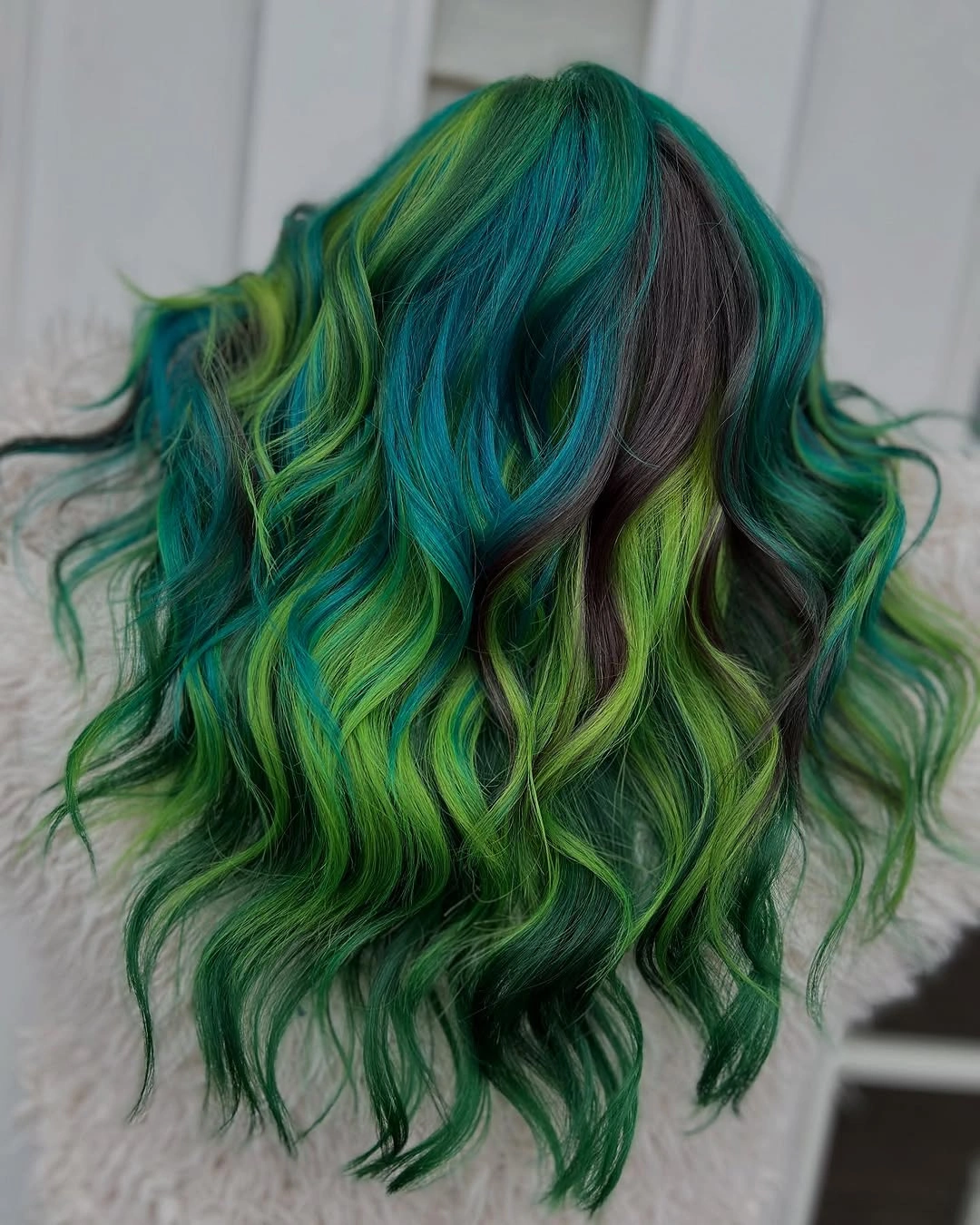 Wavy teal-green hair with lime panels and dark streaks